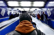 January 20, 2011. Germany, Munich, Underground metro station. Rear view of man on escalator — Stock Photo