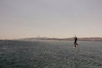 August 3, 2017. Greece, Paros. Kite surfing man in front of the Antiparos Island — Stock Photo