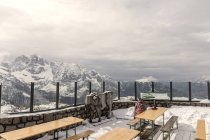 March 24, 2017. Italy, Trentino region, Madonna di Campiglio, Rifugio restaurant. Person sitting on restaurant terrace in mountains — Stock Photo