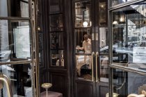 February 23, 2017. Milan, Giacomo Bistrot. Man using phone in restaurant — Stock Photo