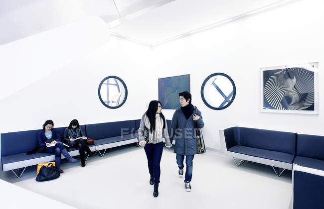 January 14, 2011. Milan, Museum of the Twentieth Century. Asian tourists walking in museum room — Stock Photo