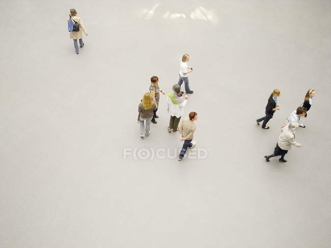 May 26, 2010. Germany, Monaco, Pinakothek der Moderne museum. Tourists walking on white floor — Stock Photo