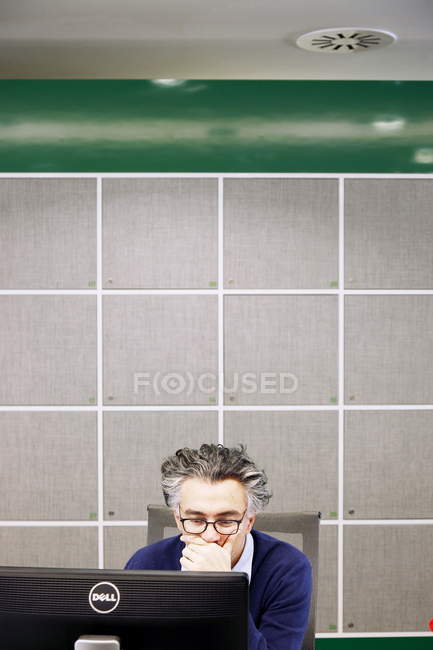 06 декабря 2013 года. Милан. Человек, работающий с компьютером в офисе — стоковое фото