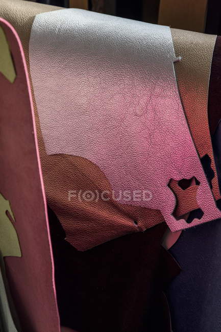 Hanging pieces of different cut leather — Stock Photo