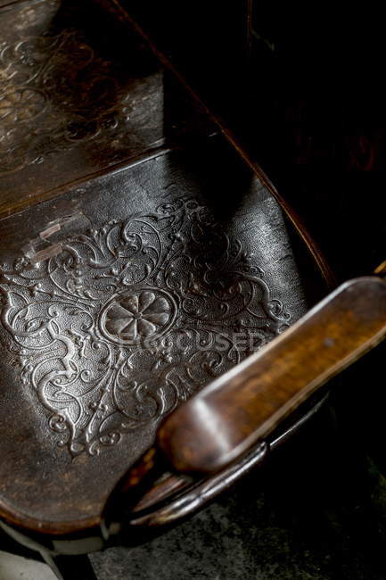 Elevated view of an old carved wooden chair — Stock Photo