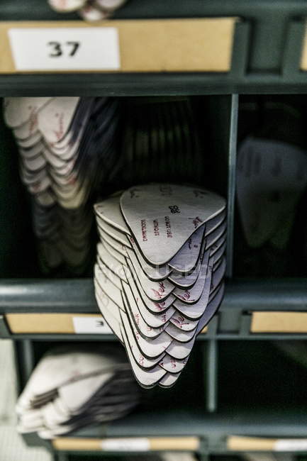 Closeup view of piled inner soles on shelves — Stock Photo