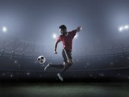 Футболіст, що демонструє навички з м'ячем на стадіоні — стокове фото