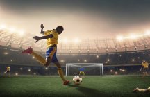 Football player shooting the ball at the goal. — Stock Photo