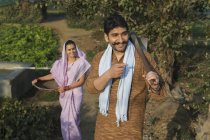 Indian man and woman in farm garden — Stock Photo