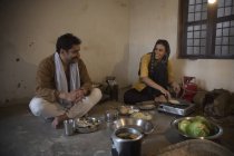 Indische Familie kocht Essen auf dem Fußboden im Haus — Stockfoto