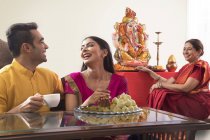 Indian family in festive clothes celebrating ganesh chaturthi indoors — Stock Photo