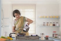 Frau bereitet Essen in Küche zu — Stockfoto