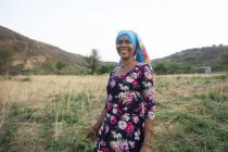 Woman standing in a farm and smiling — Stock Photo