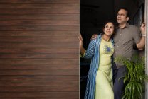 Young couple enjoying the morning sun in the balcony at home. — Stock Photo