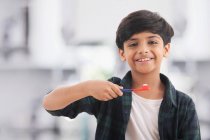 Portrait of a young boy brushing his teeth. — Stock Photo