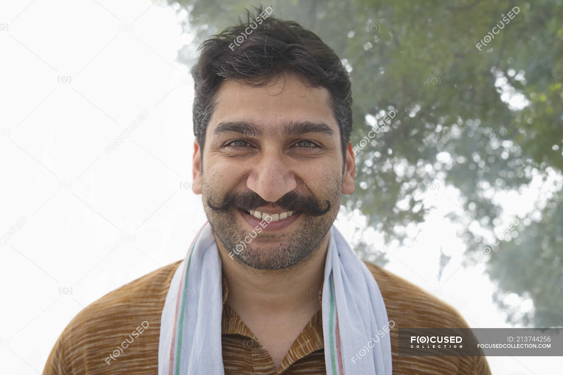 Portrait of Indian smiling village man with curled mustache — farmer