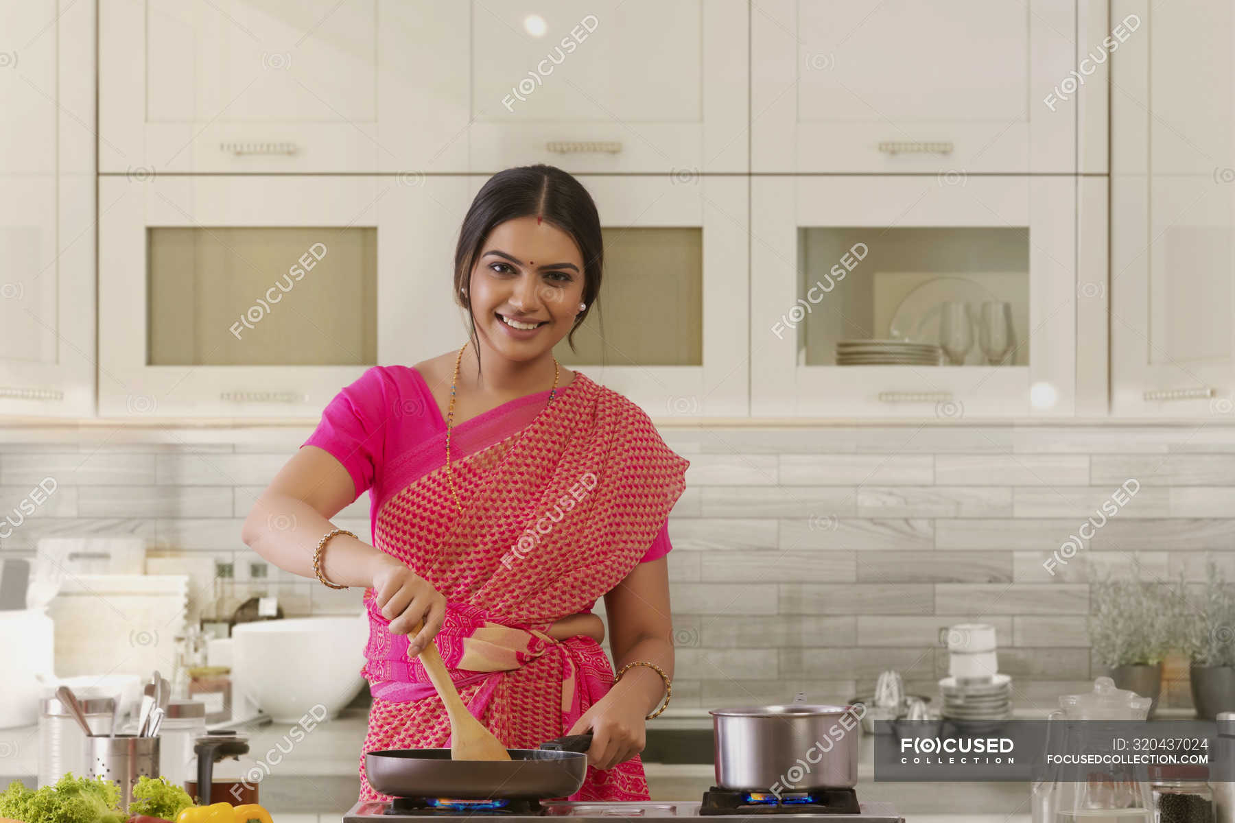 Woman in saree cooking in the kitchen — preparing, mother - Stock Photo ...