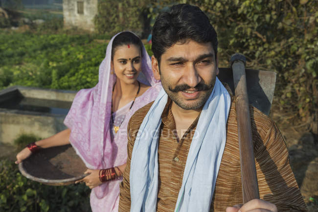Indian man and woman in farm garden — Stock Photo