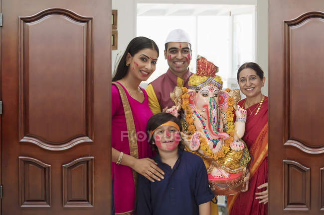 Індійська сім'я в святковому одязі, що перебуває у дверному отворі — стокове фото