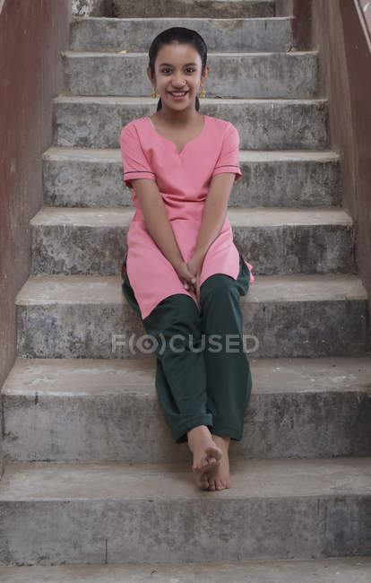 Portrait of Indian girl sitting on steps — Stock Photo