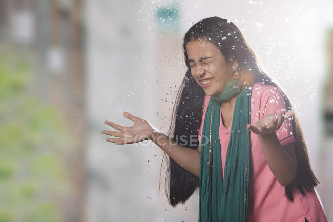 Indian girl splashing water on face — Stock Photo