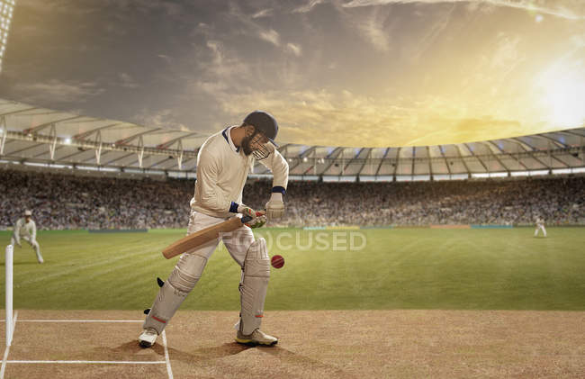 Бэтсмен в действии на поле для крикета, избирательный фокус — стоковое фото