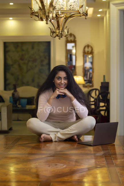 Young woman sitting on the table — Stock Photo