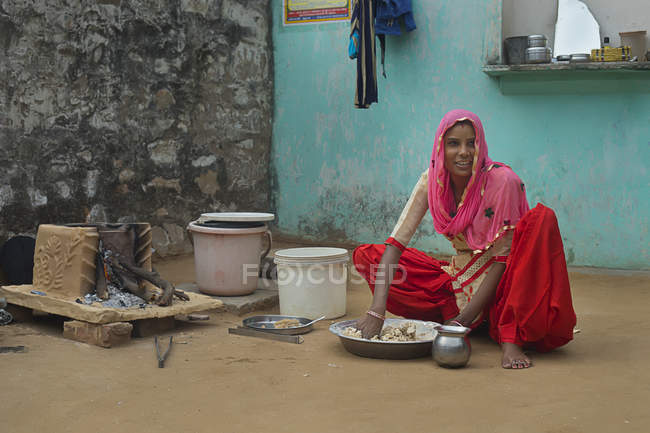 Young woman kneading flour — Stock Photo