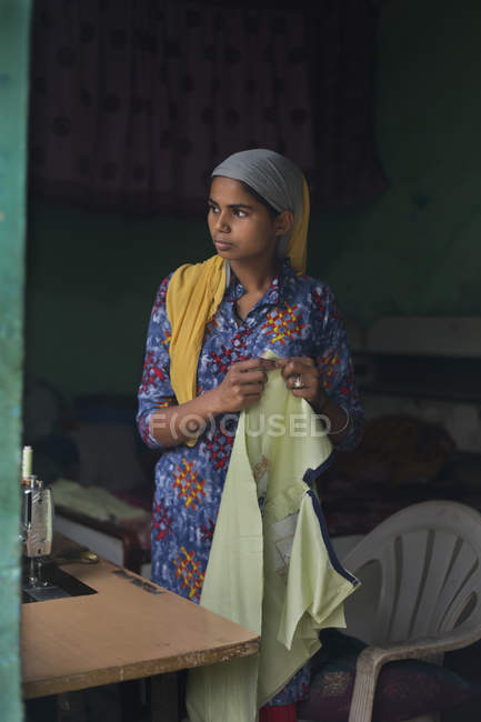 Young girl looking outside while working — Stock Photo