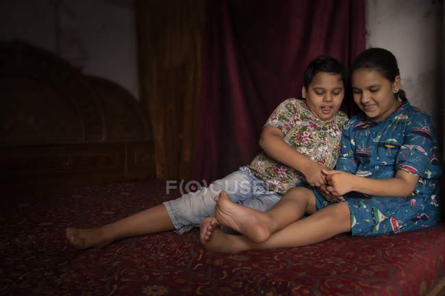 Младший брат и сестра играют дома — стоковое фото