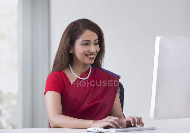 Woman working on desktop — Stock Photo