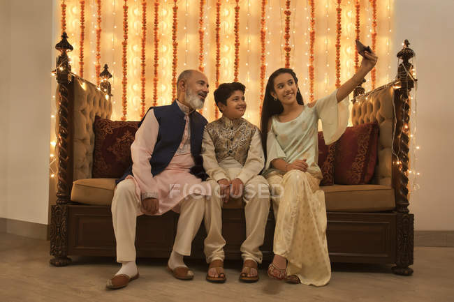 Children clicking selfie with their grandfather on Diwali — Stock Photo