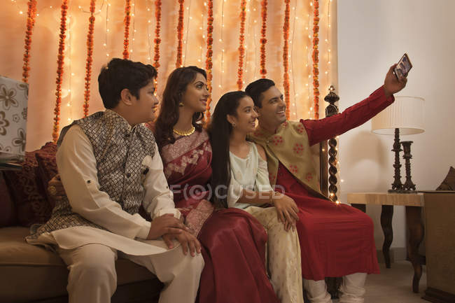 Family clicking selfie together on diwali — Stock Photo