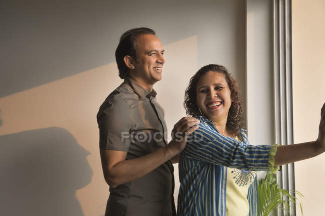 Couple standing together on the edge of the balcony at home. — Stock Photo