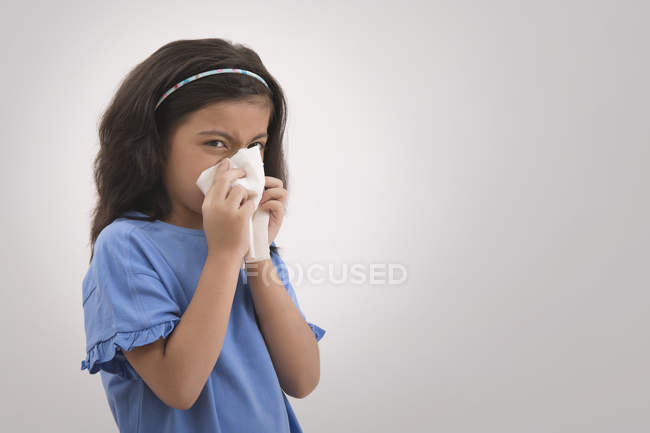 Young girl wiping her nose with a handkerchief. — Stock Photo