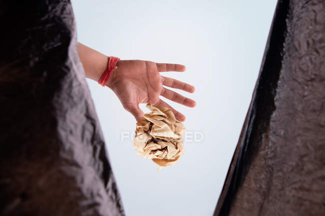 Person throwing waste inside a garbage bag. — Stock Photo
