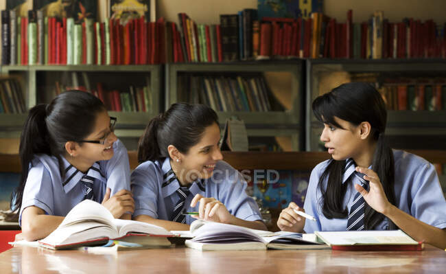 Girls in a school library — Stock Photo