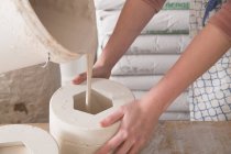 Two ceramic artists are slipcasting ceramics in a pottery workshop. — Stock Photo