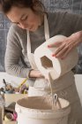 A ceramic artist is slipcasting ceramics in a pottery workshop. — Stock Photo