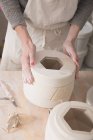 A ceramic artist is in the process of slipcasting ceramics in a pottery workshop. — Stock Photo