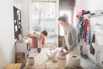 Two ceramic artists are working on their ceramics in a pottery workshop. — Stock Photo