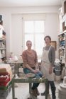 Two ceramic artists portrayed in their pottery workshop. — Stock Photo
