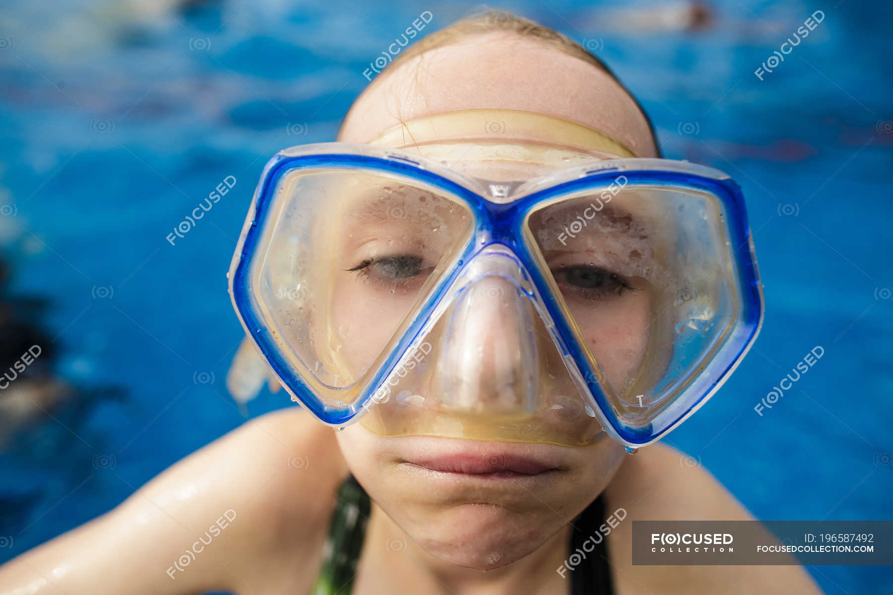 A girl in swimming pool wearing goggles and making a funny face. — - Stock | #196587492