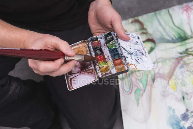 Cropped image of Creative male artist working in his workshop. — Stock Photo