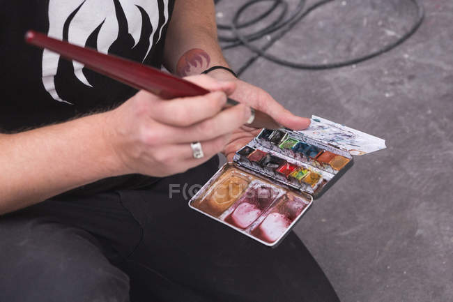 Cropped image of Creative male artist working in his workshop. — Stock Photo