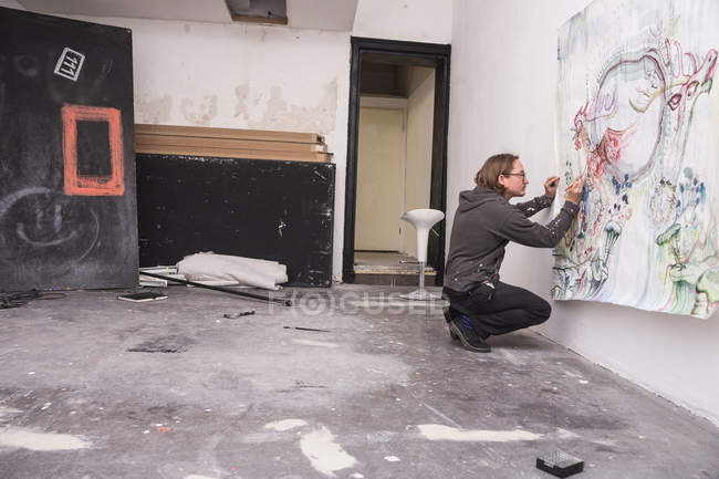 Side view of Creative male artist working in his workshop. — Stock Photo
