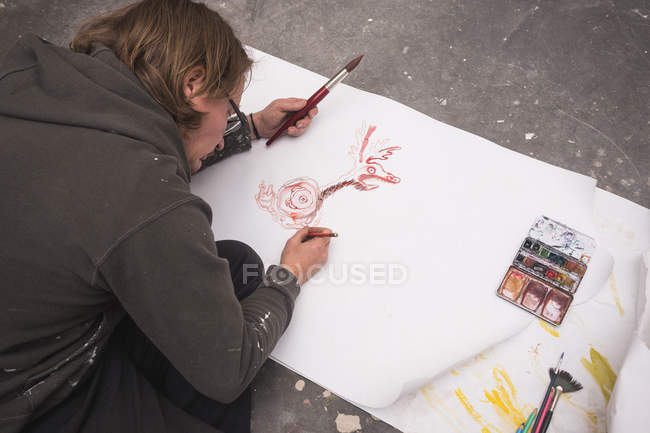 Overhead view of Creative male artist working in his workshop. — Stock Photo