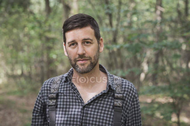 Close up of caucasian fly fisher in forest area. — Stock Photo