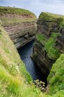 United Kingdom, Scotland, Highland, Wick, aerial view of the gorge of the Duncansby Head rugged rock formations and rock spikes — Stock Photo
