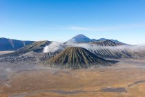 Indonesia, Java Timur, Probolinggo, Bromo smoking crater with Batok view, volcano Semeru on background — Stock Photo